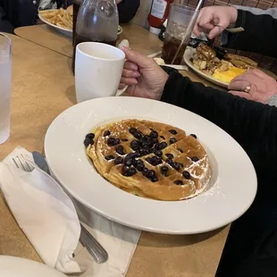 a plate of blueberry waffles