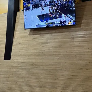 a basketball game being played on a flat screen tv