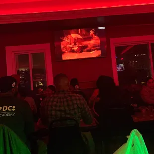 a group of people sitting in a dimly lit room