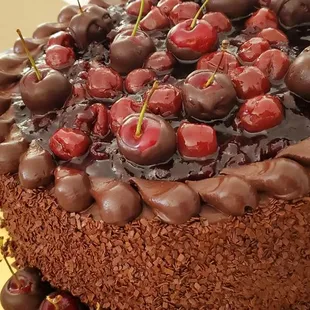 a chocolate cake with cherries on top