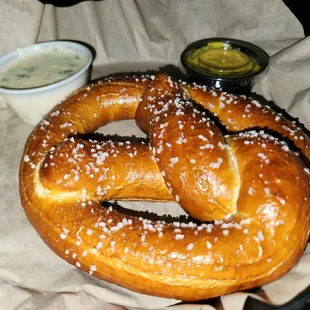 a pretzel with a side of dips