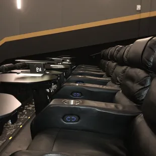 a row of recliners in a movie theater