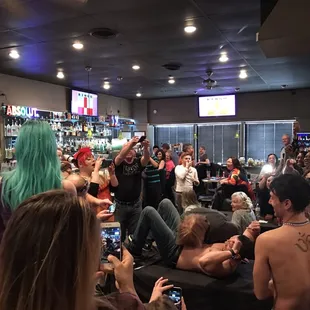 a crowd of people in a bar
