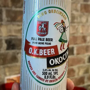 a person holding a beer can