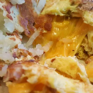 Closeup of Meat Lovers Omelette, loaded with bacon, ham, sausage and cheese (12/16/21)