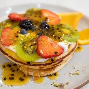 a stack of pancakes with fruit on top