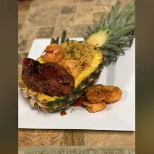 a pineapple with a grilled sausage on it