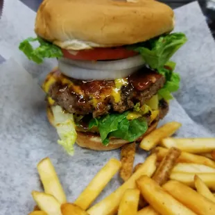 Cowboy Burger made fresh to order with House BBQ Sauce, Bacon, Cheese and the works. Never Frozen, Lean Beef