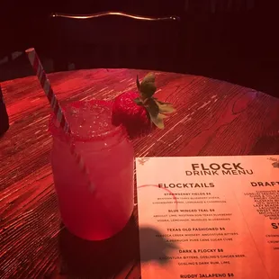a drink and menu on a wooden table