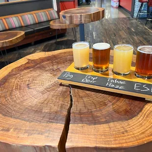 a beer flight on a tree stump