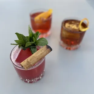 three cocktails on a table
