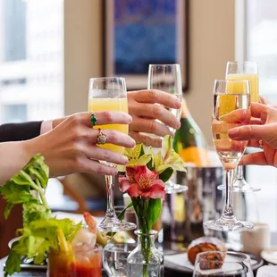 a group of people clinking glasses of champagne