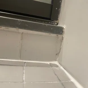a dirty bathroom with a window