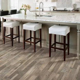 a kitchen with a center island and bar stools