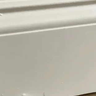 damaged baseboards after The Floor Gallery on 12331 N. ROCKWELL OKC installed vinyl flooring. The entire rooms bases were ruined.