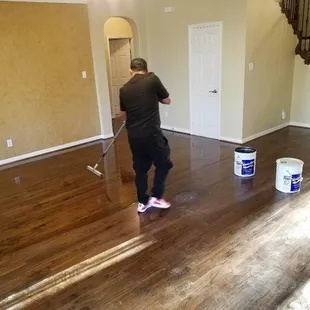 a man cleaning a hardwood floor