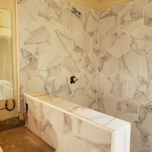 a bathroom with a marble shower