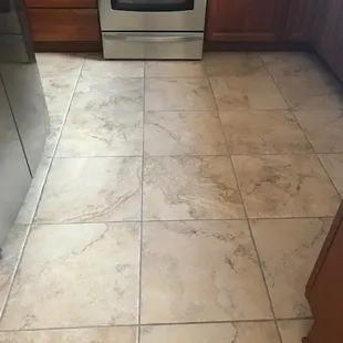 a kitchen floor with a stove and oven