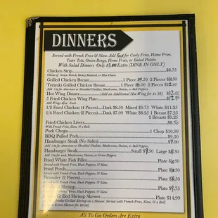 a menu on a yellow wall