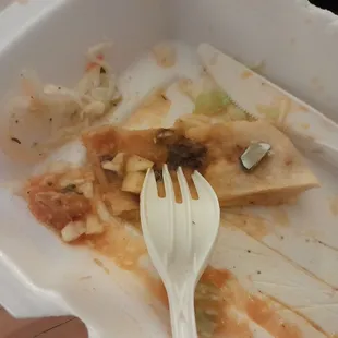 Piece of medal that was inside the pupusa. Horrible attitude when I returned to get my money back.