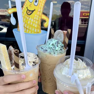 two people holding drinks