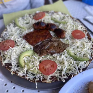 a pizza with meat and vegetables