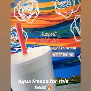 a person holding a drink in their hand