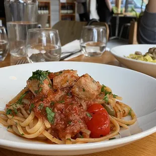 a plate of pasta with meat and vegetables