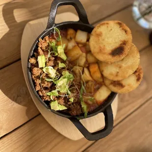 Vegan Shakshuka - potatoes and vegan chorizo instead of the eggs. Vegan arepas on top