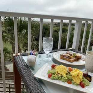 breakfast on a balcony overlooking the ocean