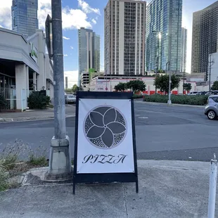 a sign on the corner of a city street