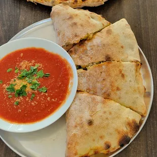 Calzone stuffed with vegan cheese and pepperoni like meat. Delicious dipping sauce to complete.