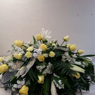 Casket spray. Any color roses with lilies.
