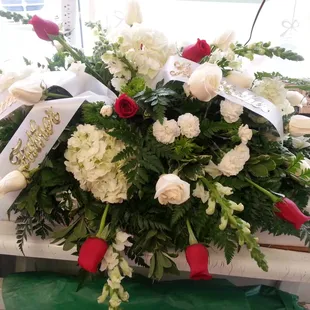 Funeral tribute with hydrangea and roses.