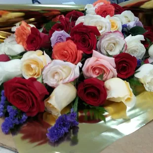 Wrapped dozen roses at $10.00/ dozen. Lots of colors.