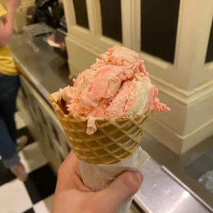 Strawberry and Peanut Butter ice cream on a waffle cone