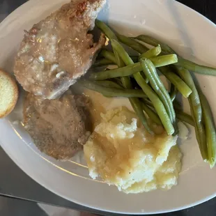 Smothered pork chops, mashed potatoes, green beans &amp; cornbread.