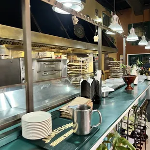 a restaurant counter with dishes on it