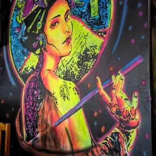 a mural of a woman smoking a cigarette