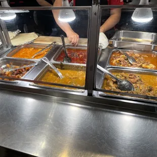 a person serving food from a buffet