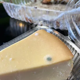 a piece of cheesecake in a plastic container