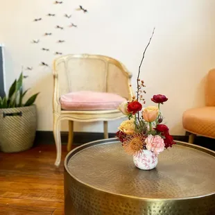 a vase of flowers on a table in a living room
