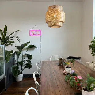 a dining room with a wooden table and white chairs