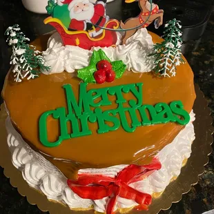 a christmas cake decorated with santa and sleigh