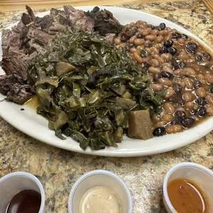 Chopped brisket with 2 sides-collard greens and dirty beans.