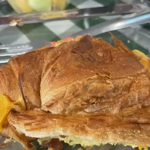 Scrambled egg &amp; bacon on a flaky croissant