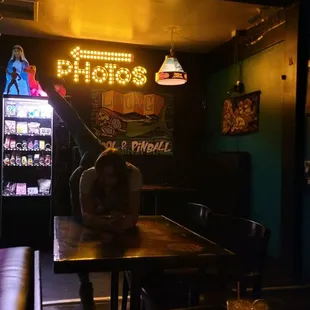 a person sitting at a table with a drink