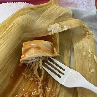 What's left of a tamale with hot sauce.