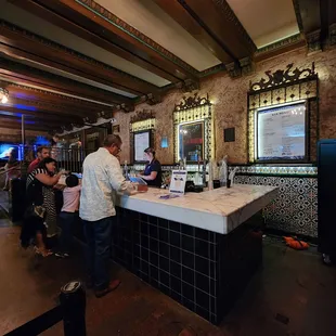 a man ordering wine at a bar