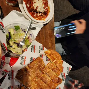 Baked spaghetti, antipasto salad, and bread